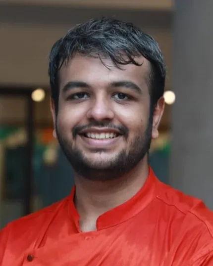 Prithvi Singh, smiling, in an orange kurta